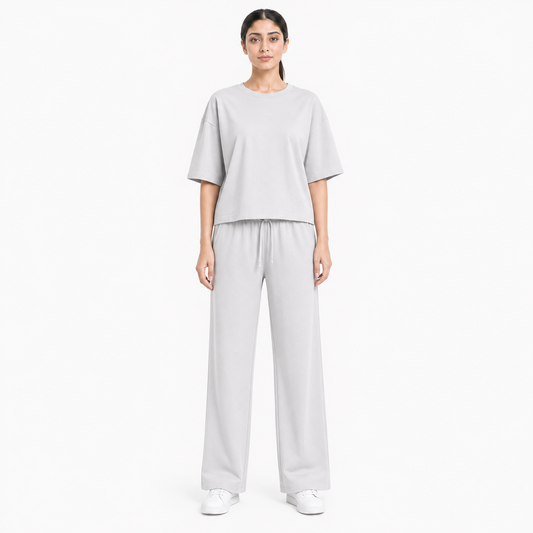 Woman wearing the Light Grey Drop Shoulder tracksuit, front view